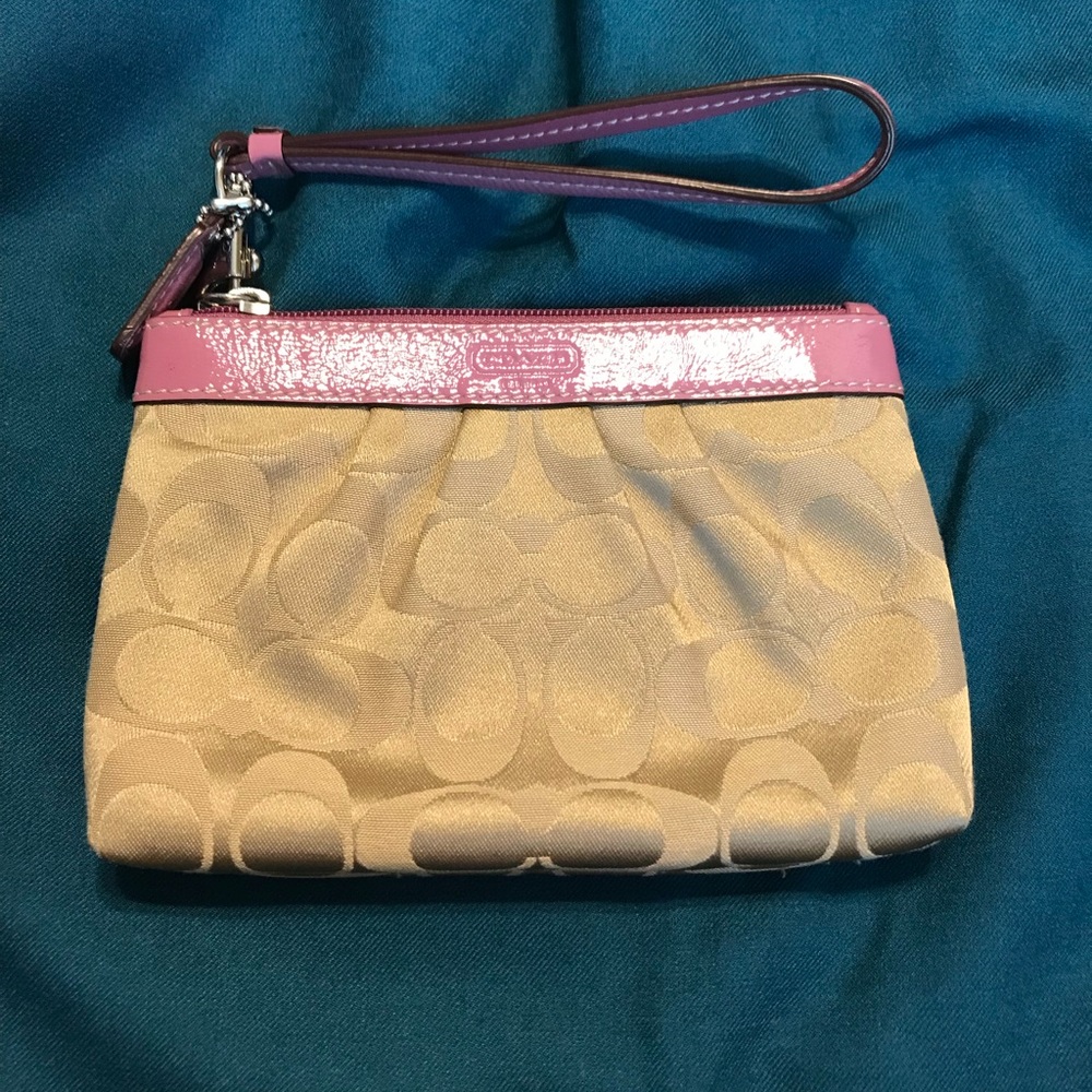 Tan and pink signature Coach wristlet